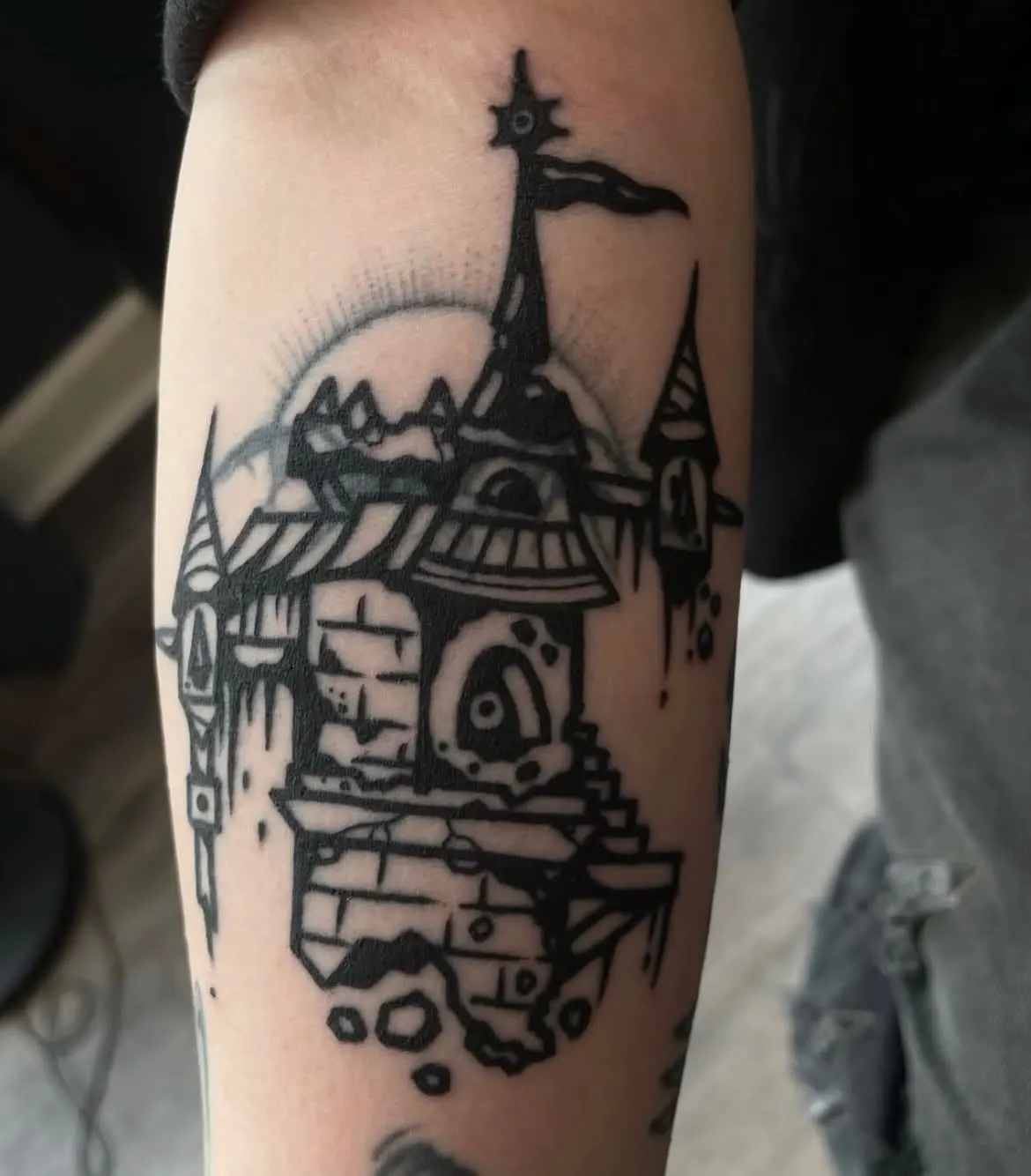 Blackwork castle tattoo on a forearm by Inkspatters Wolf & Dagger Tattoo Hove
