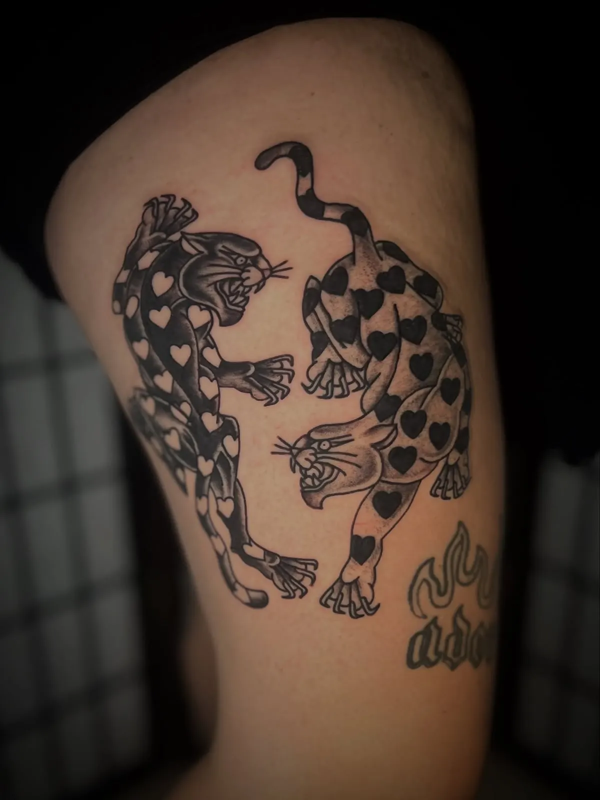 Close up of traditional panther tattoos on a thigh Wolf & Dagger Tattoo Hove