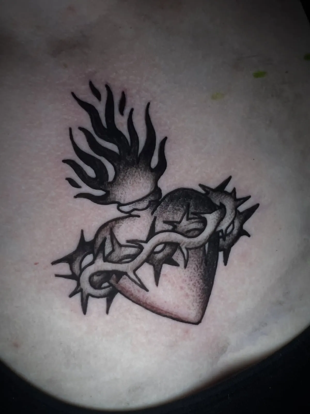 Blackwork sacred heart with flames and thorns tattoo Wolf & Dagger Tattoo Hove