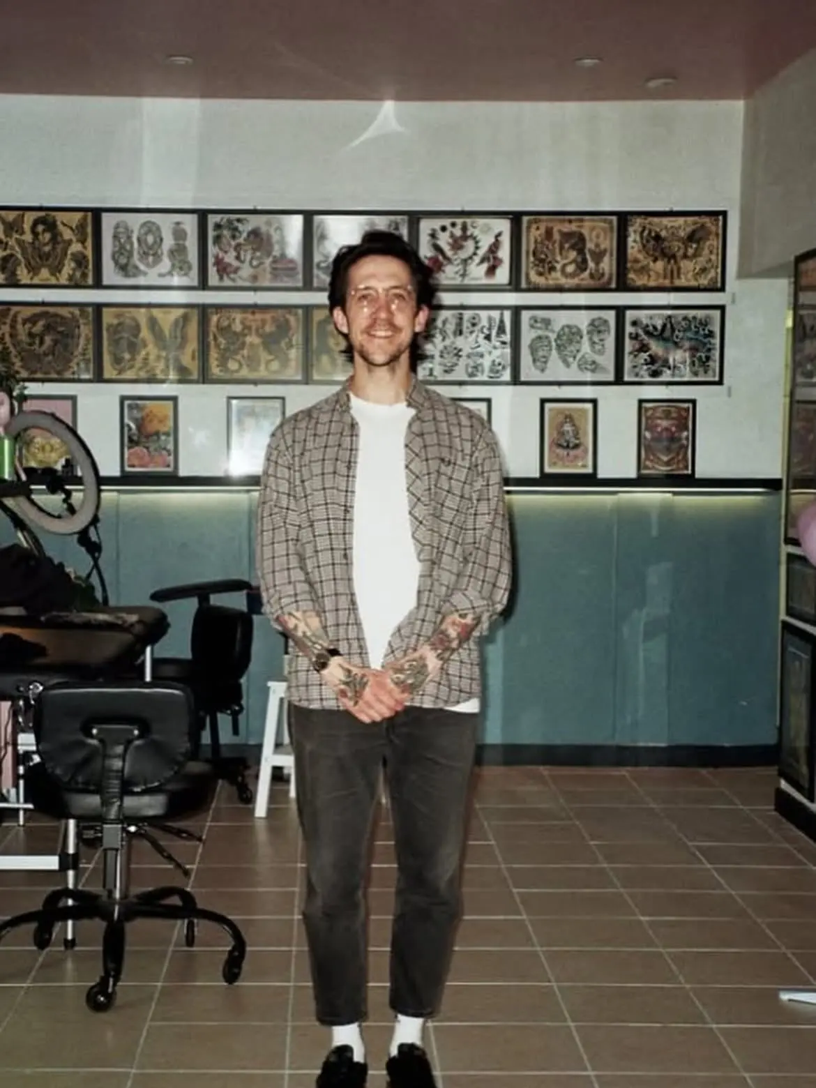 Inside Wolf & Dagger studio Hove with walls of framed tattoo flash
